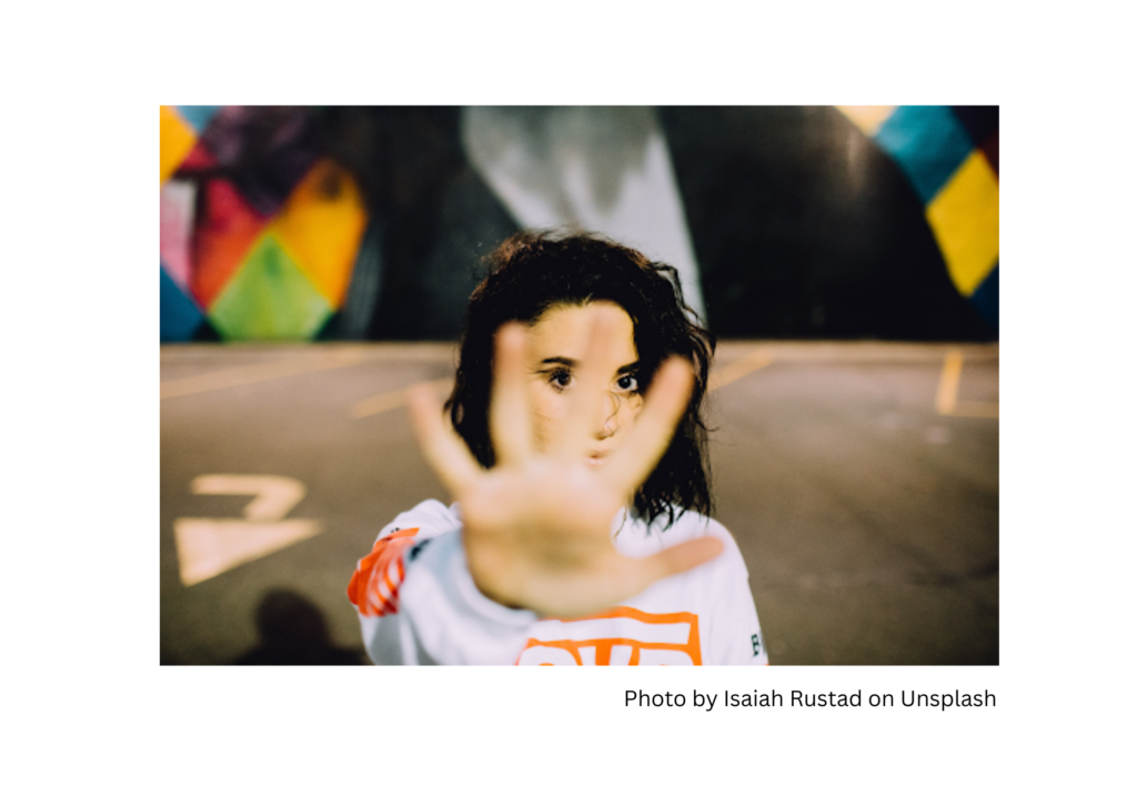 woman with hand held out in a blocking posture